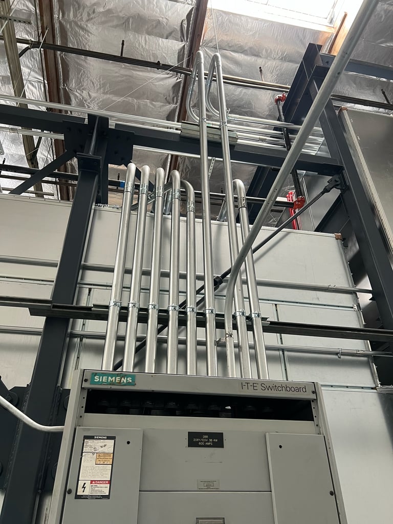 Siemens electrical switchboard with metal conduit and wiring in industrial installation